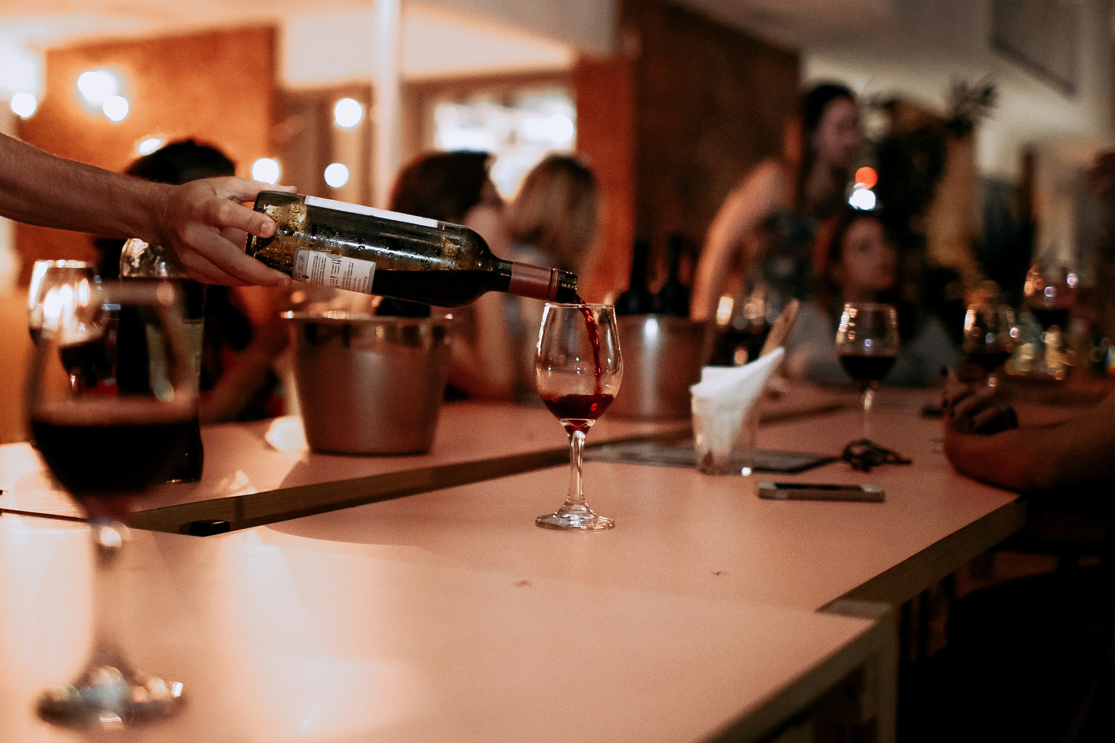 Tasting bar — red wine being poured at the counter